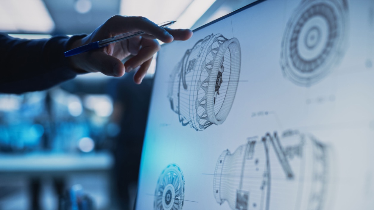 Engineer reviewing aerospace component schematics on screen