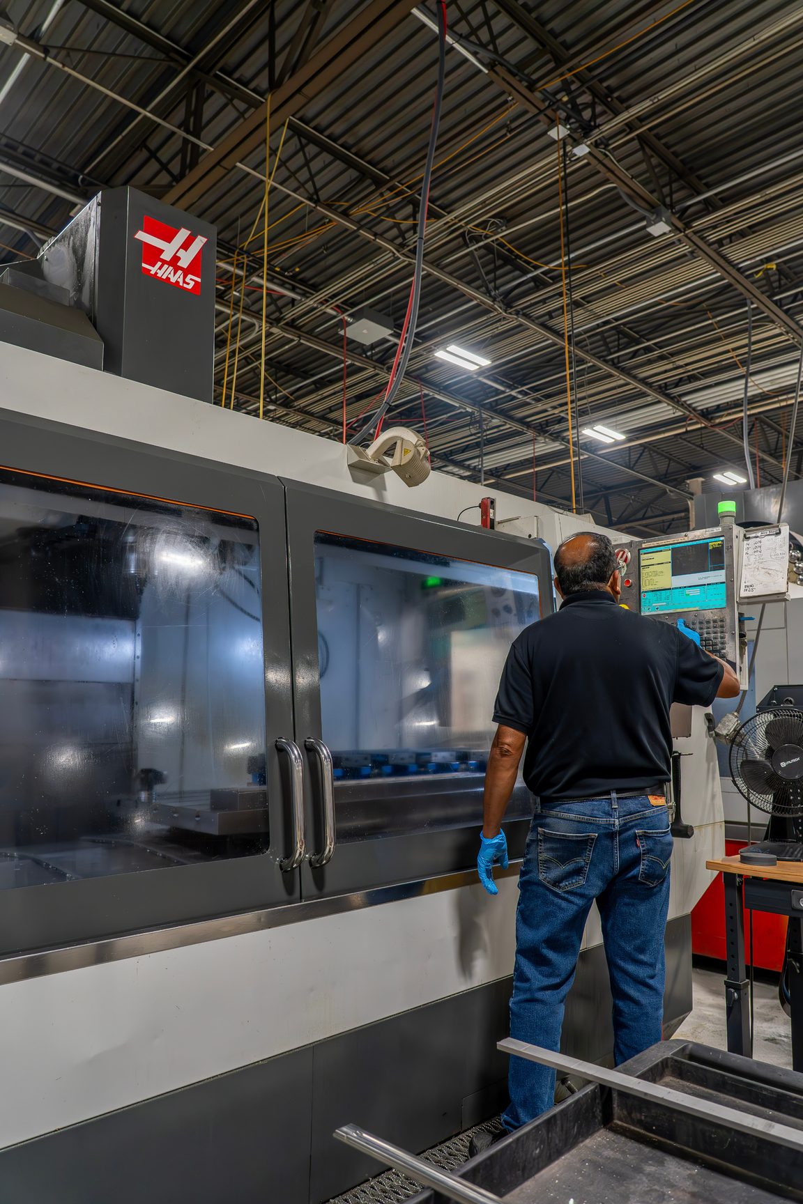 Machinist operating precision CNC equipment