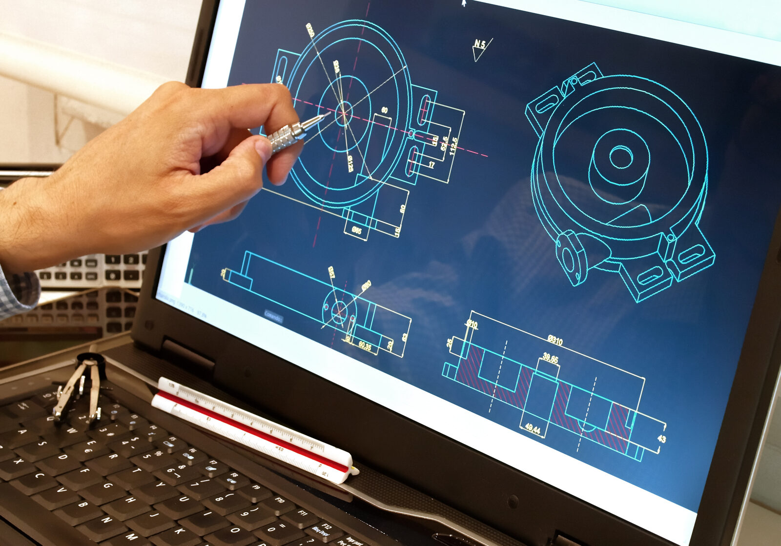 Engineer pointing at CAD drawings on screen