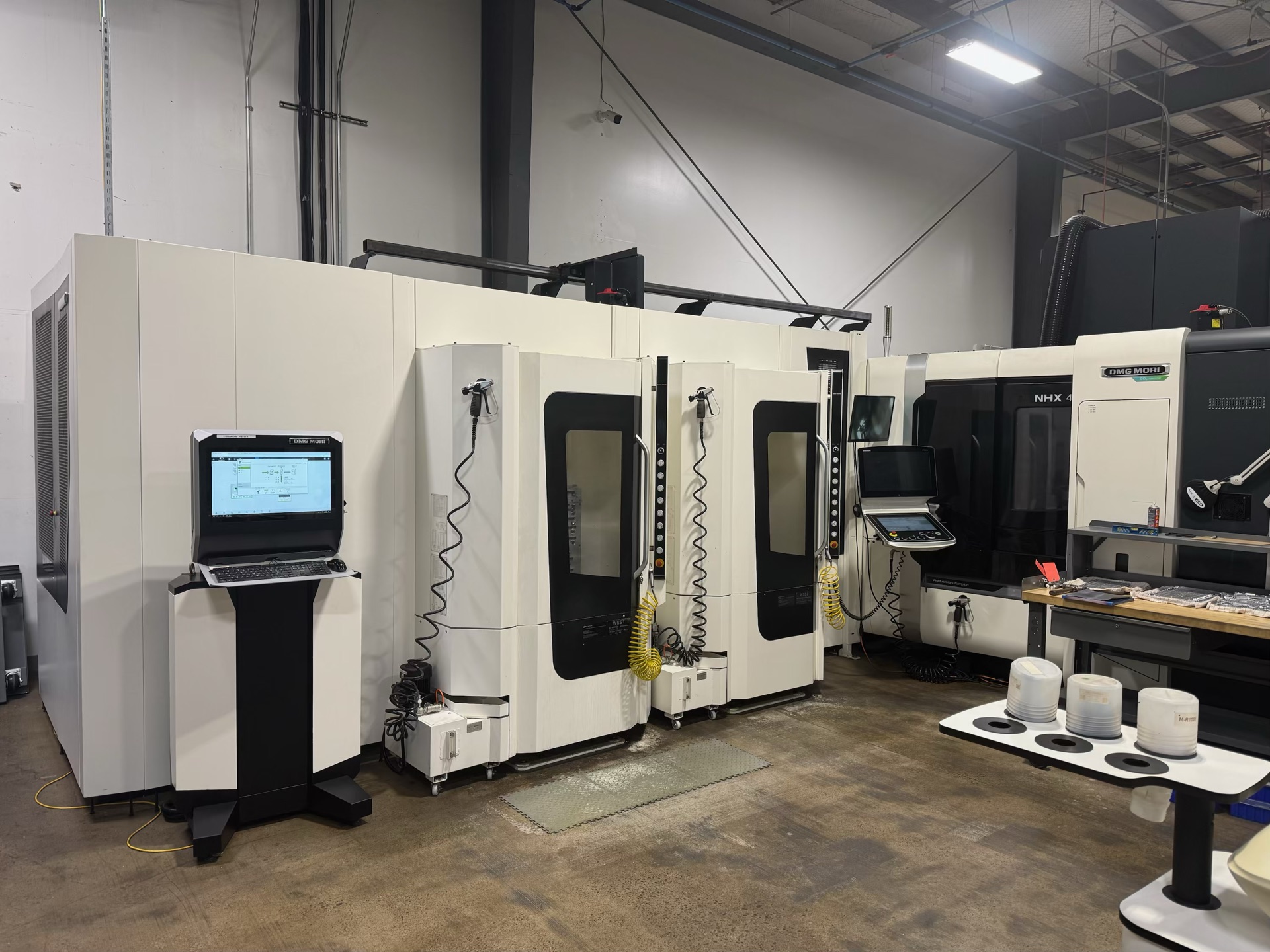 DMG MORI NHX horizontal machining centers with a linear pallet pool on a Compass Precision shop floor